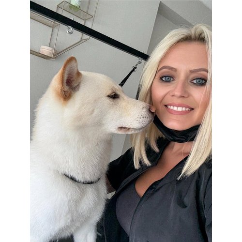 Michelle Adams, founder of The Grooming Boutique, with a happy client in her home-based salon